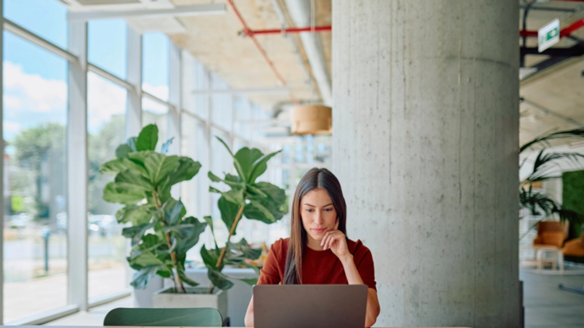 an image of a woman using a laptop in a cafe