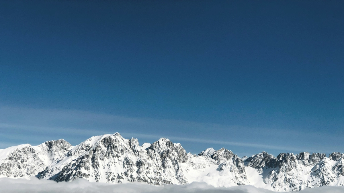 A photo of snow capped mountains in the distance