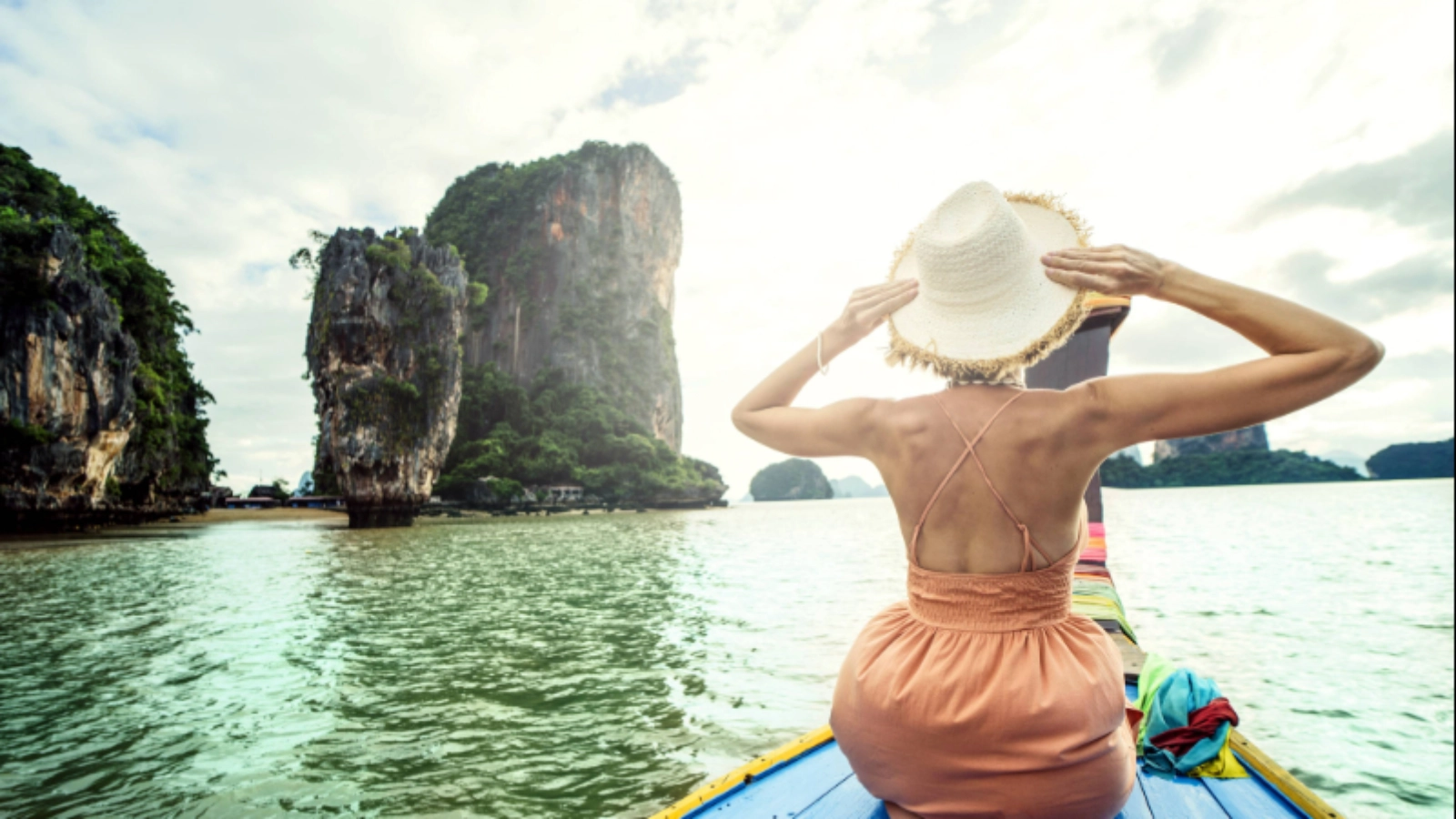 Female traveller on the long tail boat looking at the James Bond island Phuket